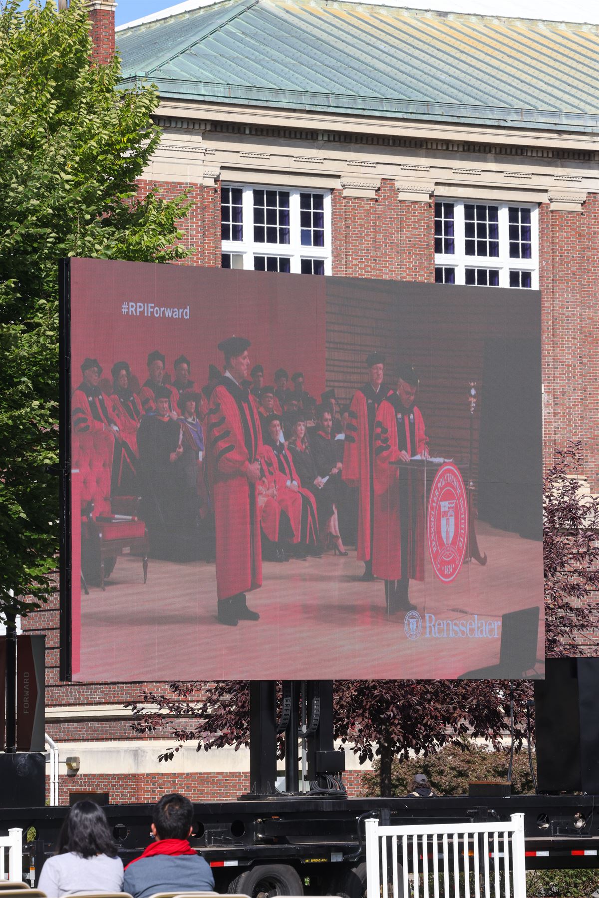 Video on President’s investiture on outdoor screen.