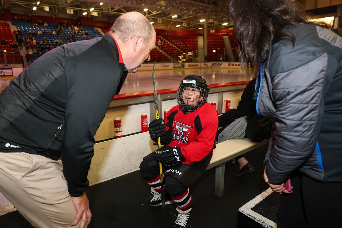 President Marty Schmidt greeting a young hockey fan at the Field House.