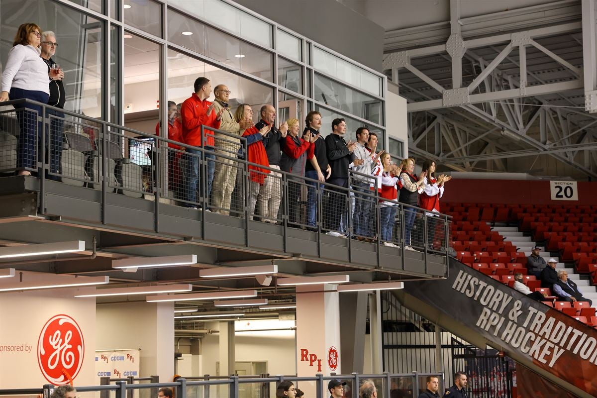 President Marty Schmidt with alumni overlooking the hockey game from the balcony at the Field House.