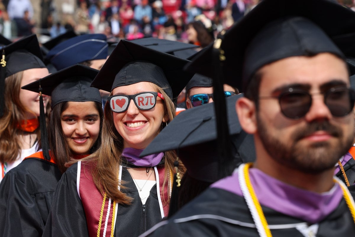 Smiling student wearing IloveRPI sunglasses at Commencement.