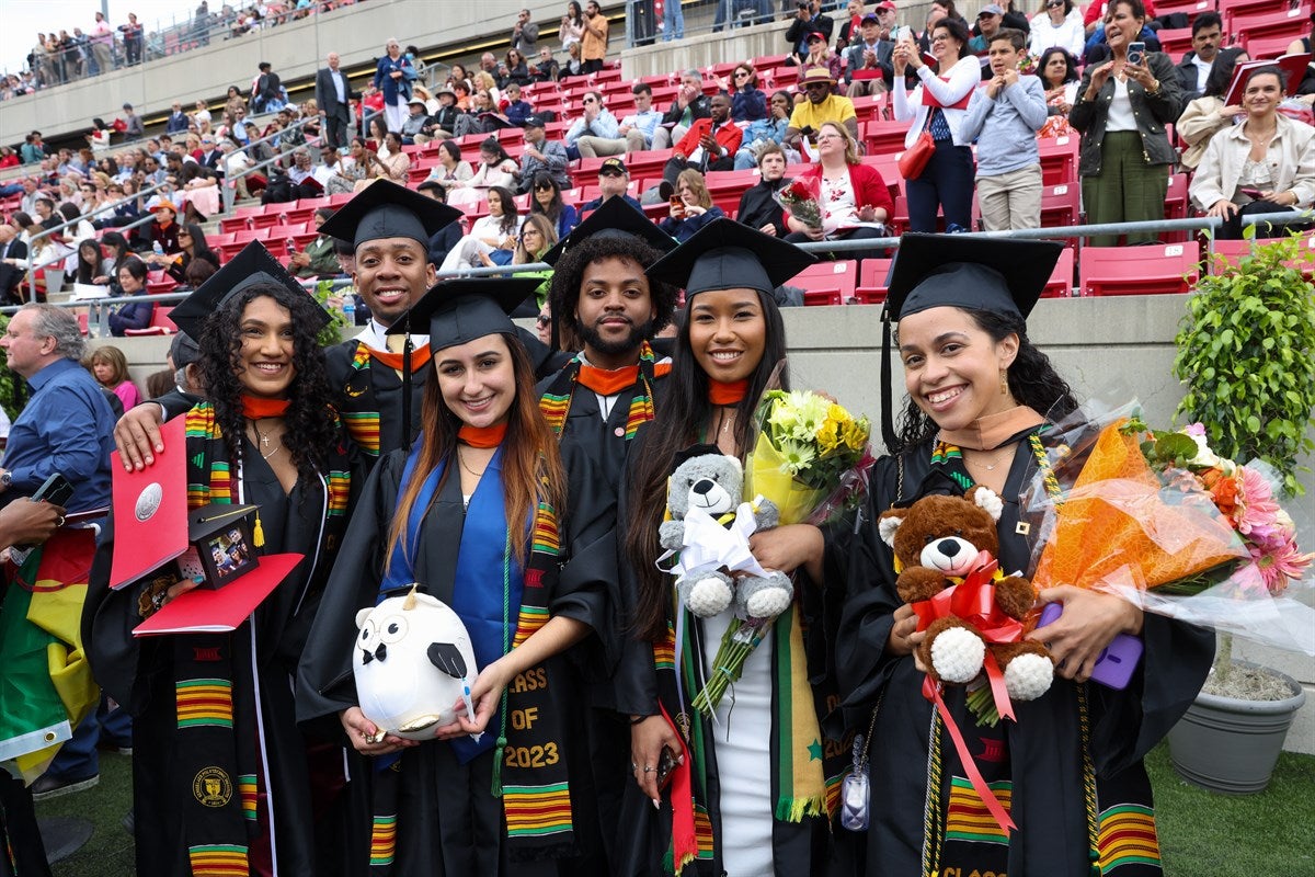 Diverse group of students celebrate after Commencement ceremony.