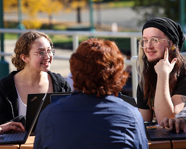 RPI students sitting and chatting outside, reflecting a welcoming, inclusive community committed to learning and collaboration