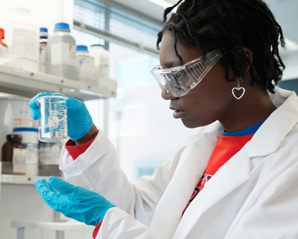 RPI student conducting research in a lab, representing the institute’s legacy of groundbreaking discoveries and life-changing innovations