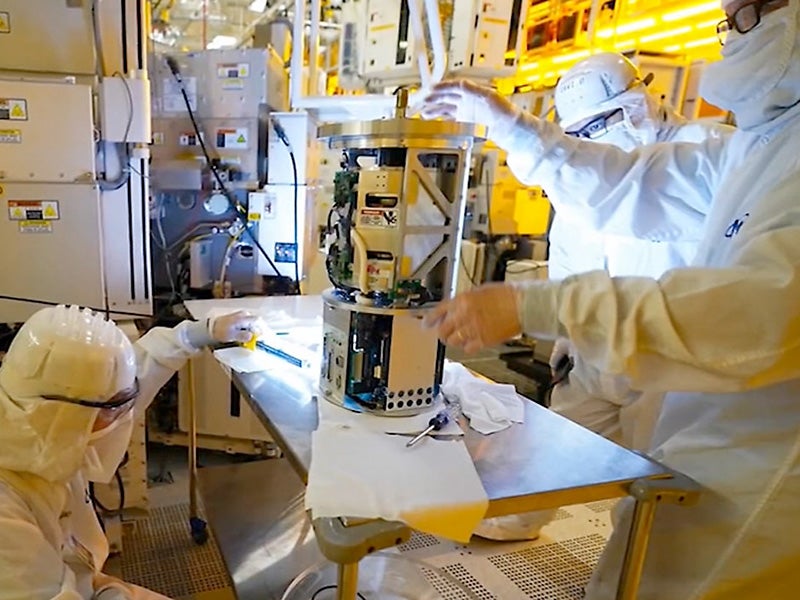 Scientist in cleanroom work with chip technology