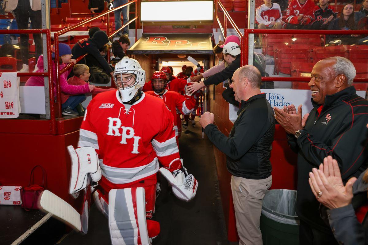 President Marty Schmidt greeting a hockey player at the Field House.