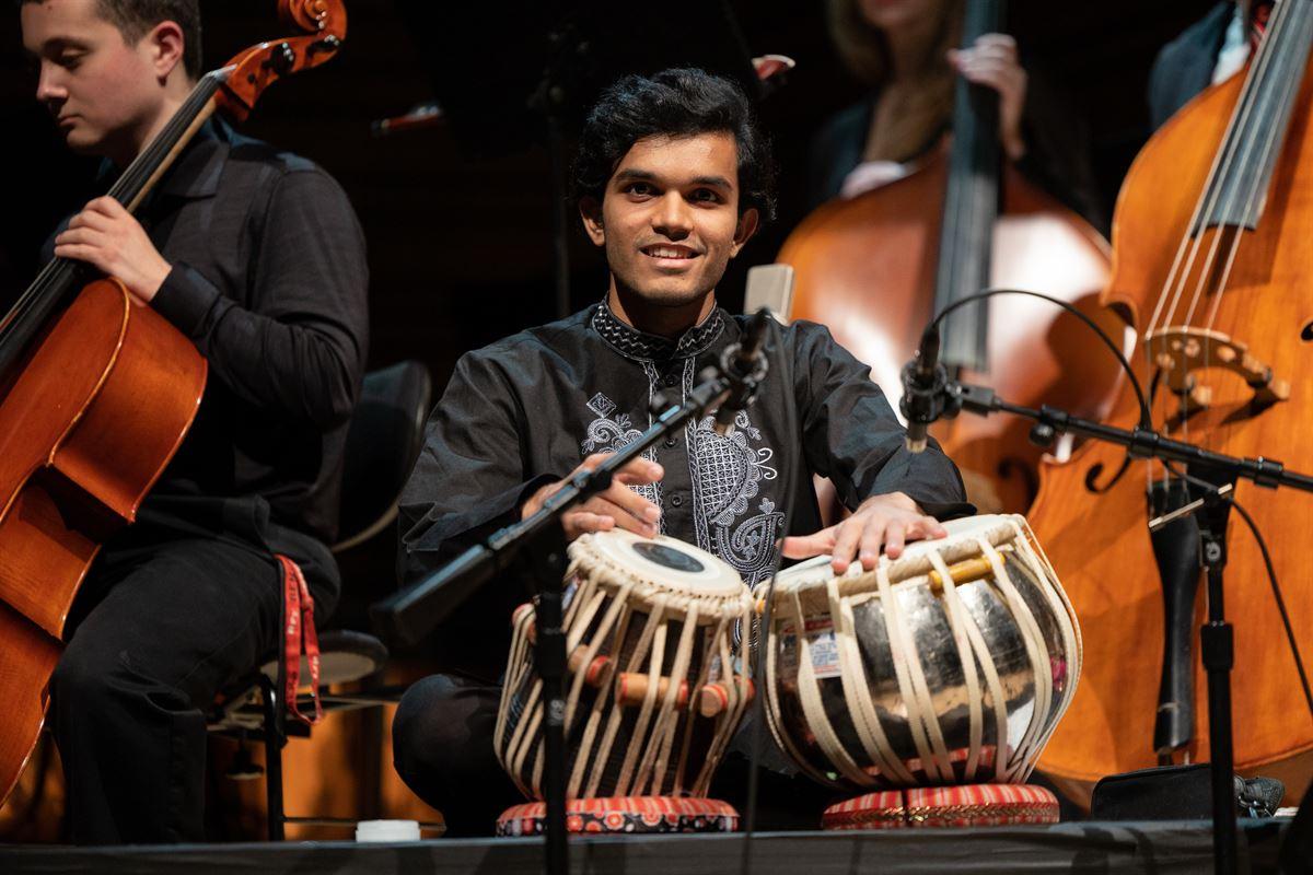 Tabla player performing on stage.