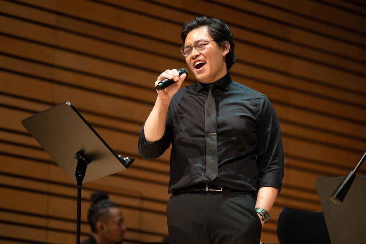 Soloist male singer on stage at the Holiday Concert.