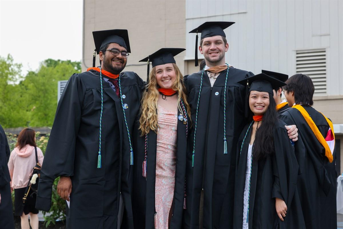 Smiling group of students in lineup prior to start of Commencement.