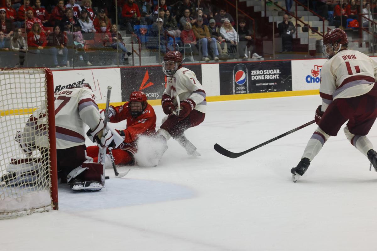 A hockey player from RPI attempts a goal as a Colgate goalie makes a save during the Big Red Freakout.