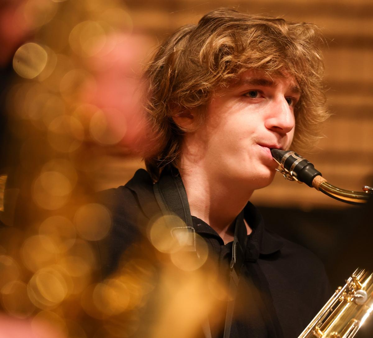 Student musician playing saxophone at RPI's holiday concert.