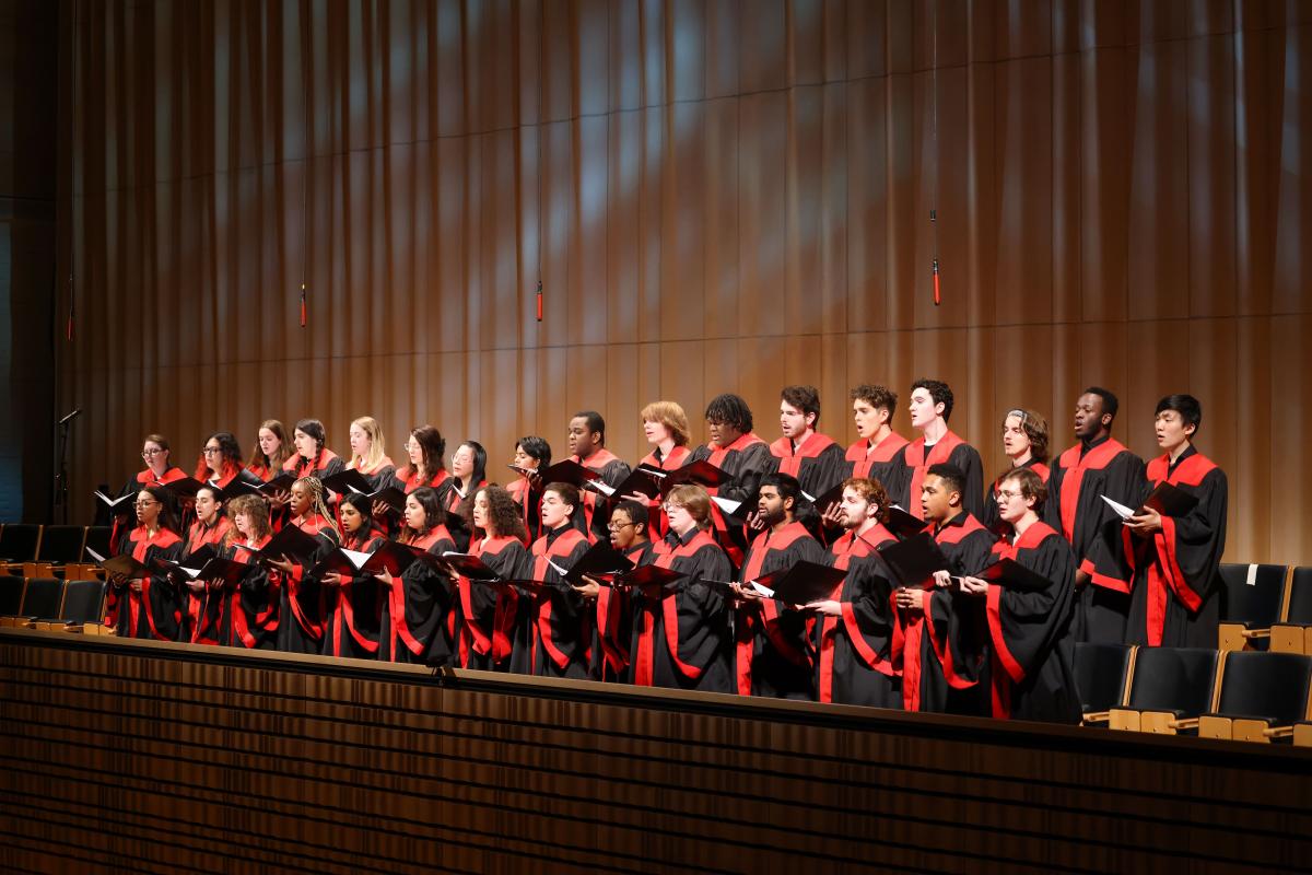 Members of RPI's Concert Choir singing in red and black robes during RPI's holiday concert.