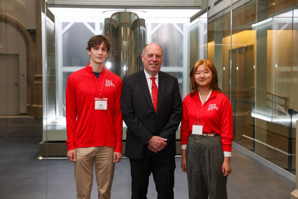 RPI President Martin. Schmidt poses in front of the IBM Quantum System One with two members of RPI's Quantum Club.