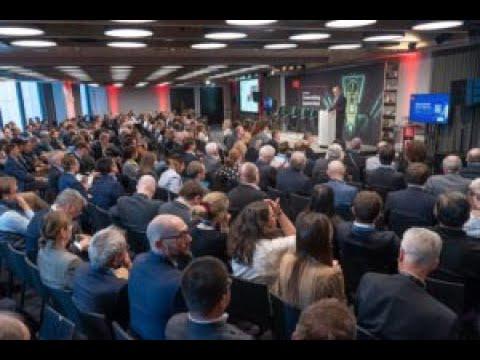President Schmidt delivering a keynote to a crowd of people 