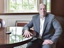 President schmidt poses in his office