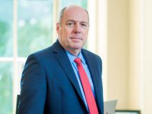 President schmidt poses in his office