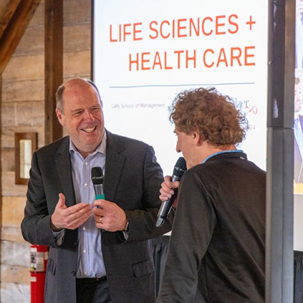 President Schmidt introduces a speaker at the Life Sciences + Health Care summit